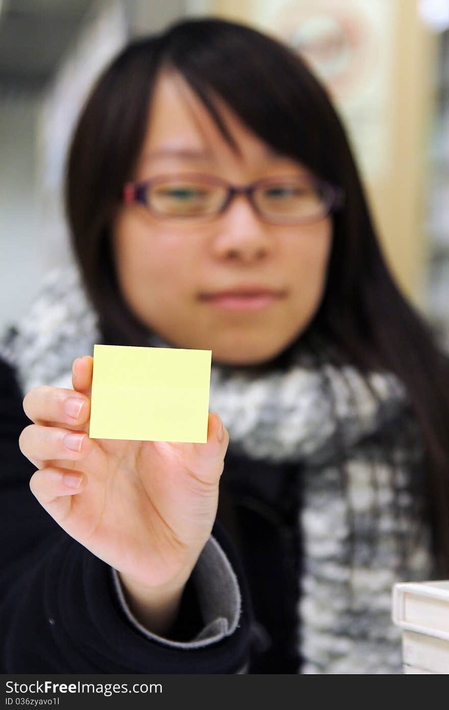 A Girl Who Is Holding A Yellow Memo Notepaper