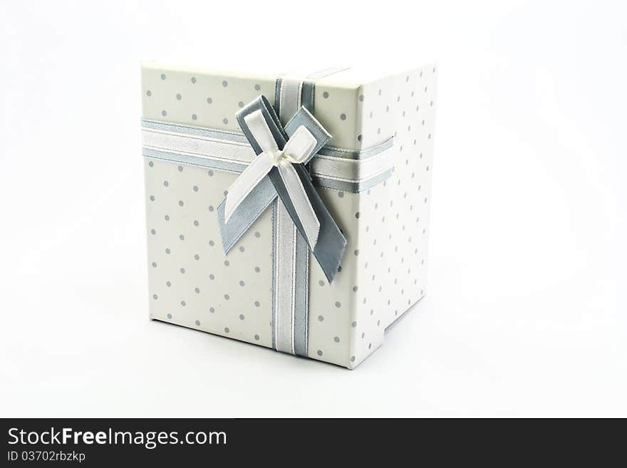 Gift box with ribbon and bow on the white background