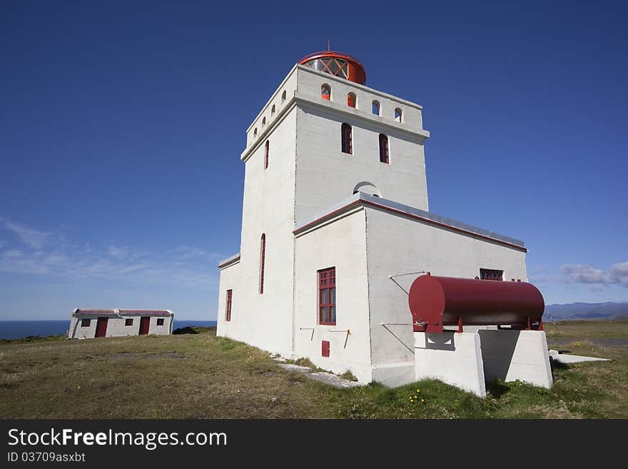 The very first lighthouse was built on Dyrhólaey in 1910. The present lighthouse was built in 1927, and the building materials were transported by boat to the port Dyrhólahöfn and pulled up onto the promontory along a cable from the shore. The lighthouse is quite a large construction, three-storeys high. During the first decades after the lighthouse was built, the lighthouse keeper had a sheepcote and a barn not far from the lighthouse, and around the houses he grew grass and made hay. The very first lighthouse was built on Dyrhólaey in 1910. The present lighthouse was built in 1927, and the building materials were transported by boat to the port Dyrhólahöfn and pulled up onto the promontory along a cable from the shore. The lighthouse is quite a large construction, three-storeys high. During the first decades after the lighthouse was built, the lighthouse keeper had a sheepcote and a barn not far from the lighthouse, and around the houses he grew grass and made hay.