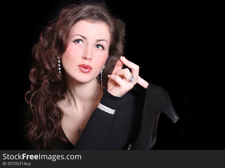 Beautiful elegant woman holding a shoe