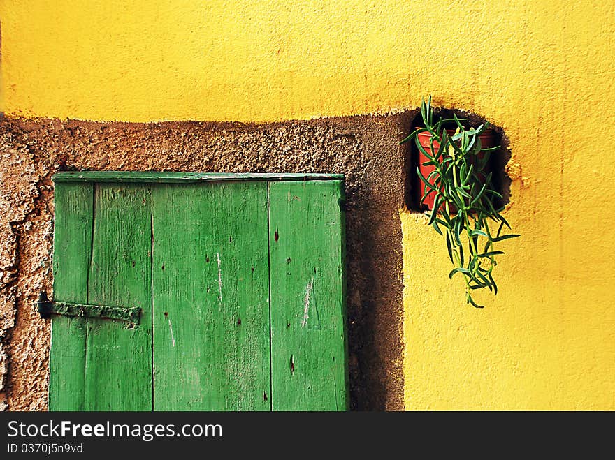 Adriatic island green door on yellow wall