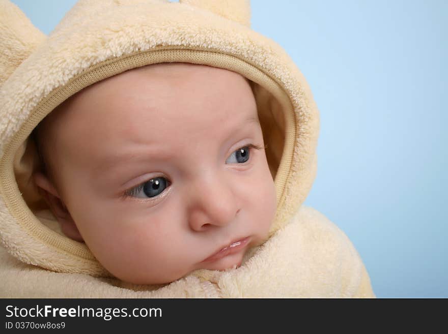 Two month old baby boy wearing a soft animal suit