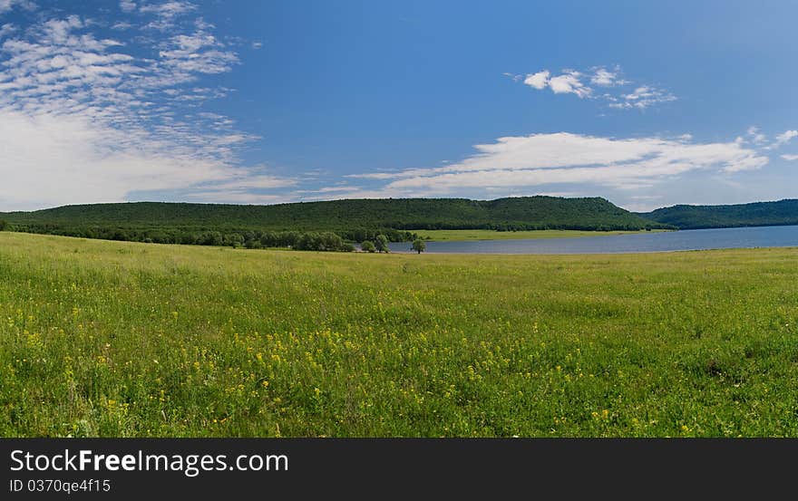 Lake Nugush, Bashkortostan, Russia, Privolnaya field, june, sunny lake, over kuperlya waterfall. Lake Nugush, Bashkortostan, Russia, Privolnaya field, june, sunny lake, over kuperlya waterfall