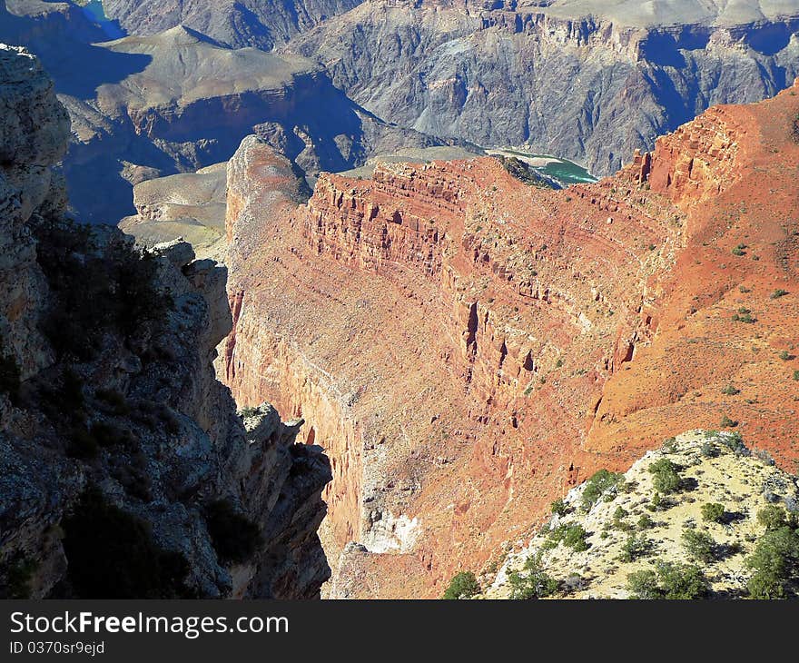 Grand canyon steep drop off with river rapids at bottom. Grand canyon steep drop off with river rapids at bottom