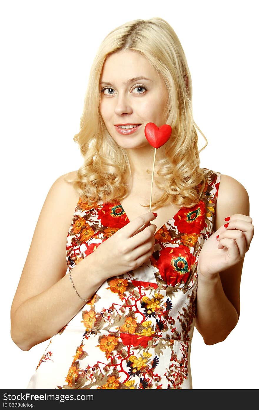 Close-up of a beautiful young woman with a red heart. Isolated on a white background