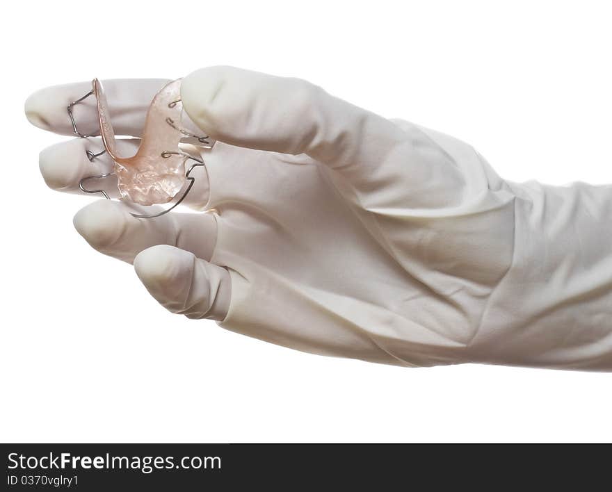 Doctor hand with surgical glove holding a braces