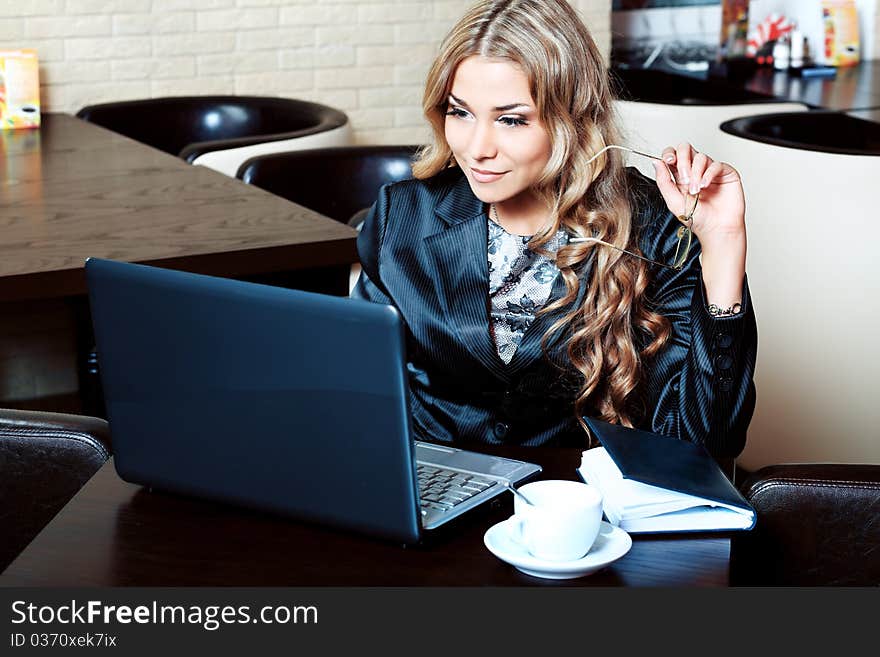 Young business woman having a break at a caf. Young business woman having a break at a caf