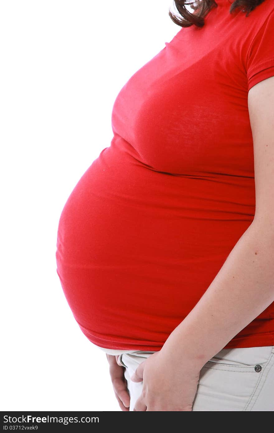 Close up of a pregnant belly over white background