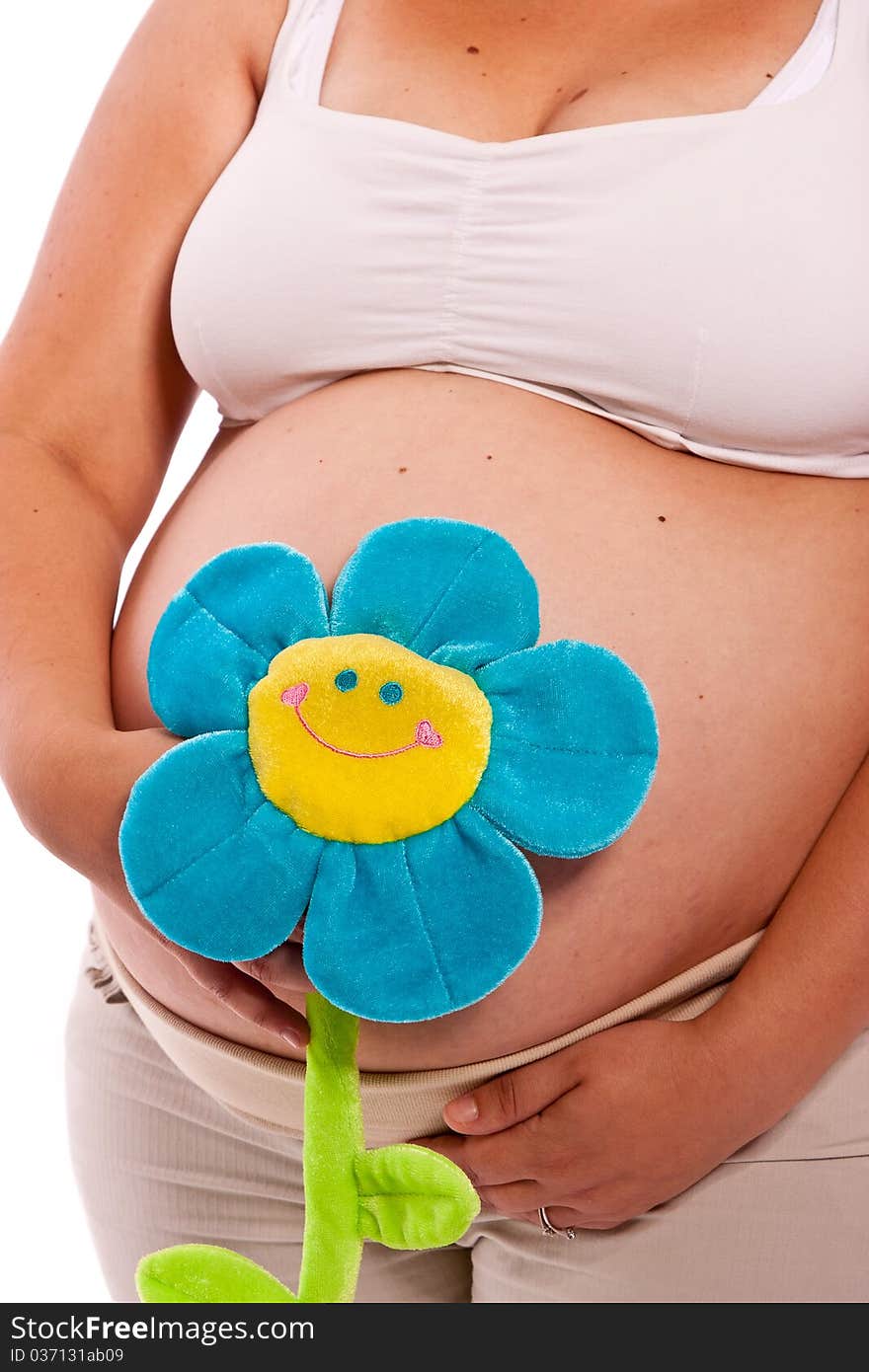 Close up of a pregnant belly over white background with a blue flower, concept expecting a baby boy. Close up of a pregnant belly over white background with a blue flower, concept expecting a baby boy