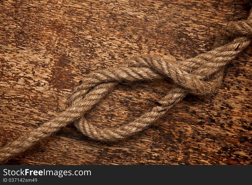 Rope on dirty wood background