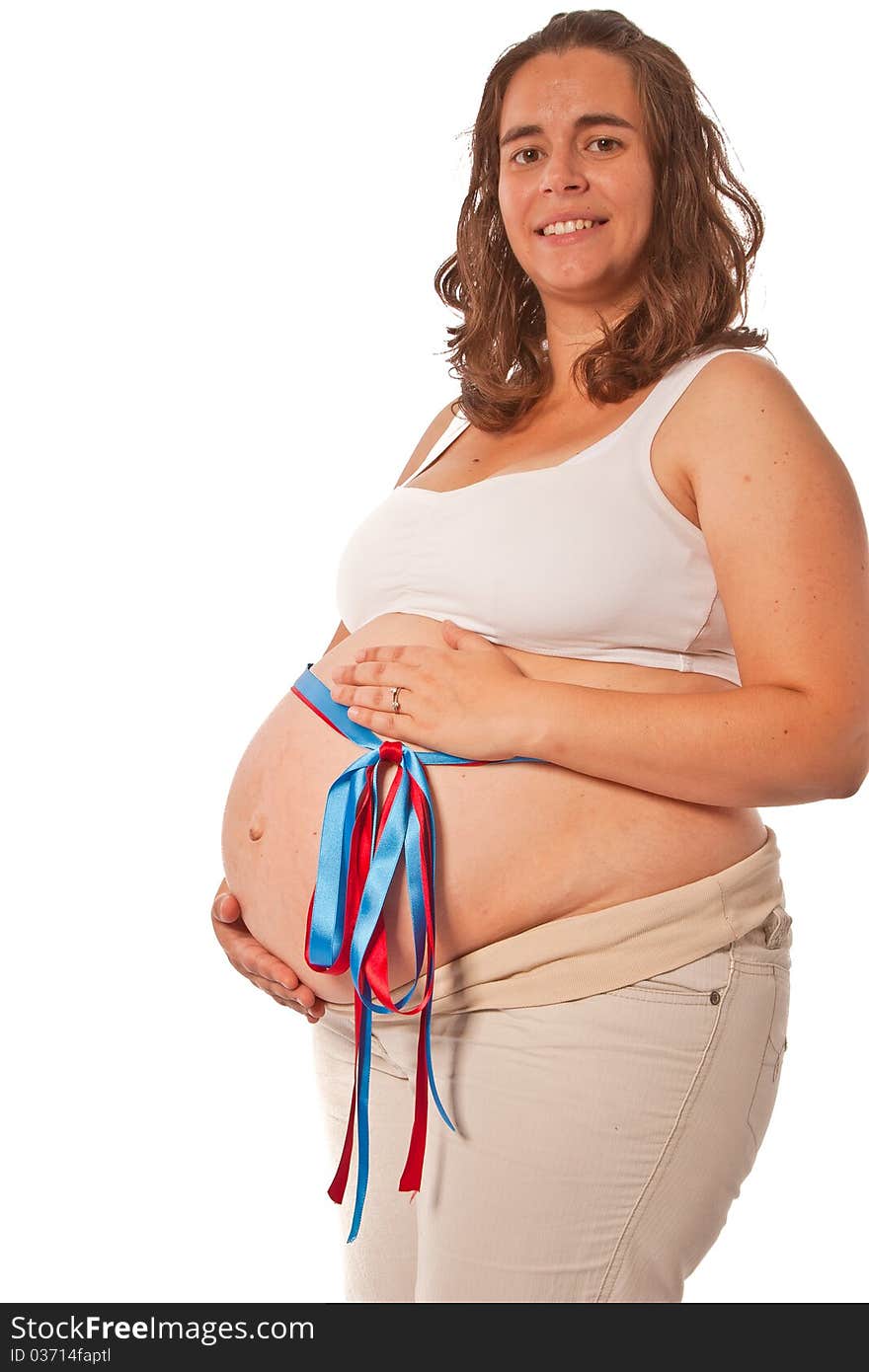 Pregnant belly with a red and blue ribbon concept of expecting twins or not knowing if is't a boy or girl. Pregnant belly with a red and blue ribbon concept of expecting twins or not knowing if is't a boy or girl