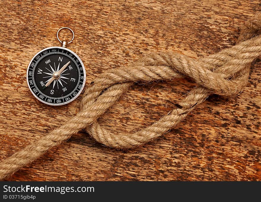 Compass and rope on grunge background