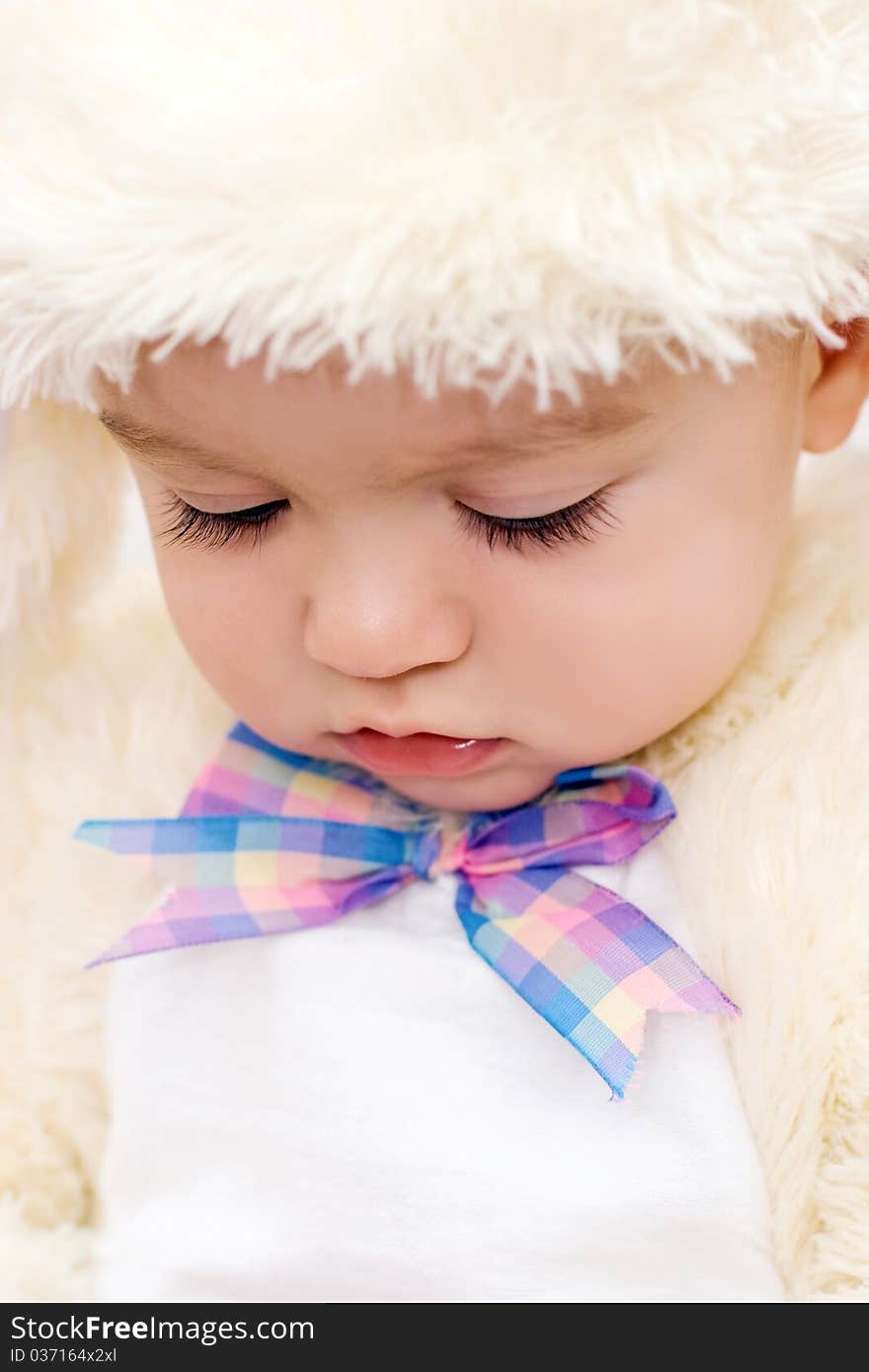 Pretty caucasian baby looking down portrait. Pretty caucasian baby looking down portrait