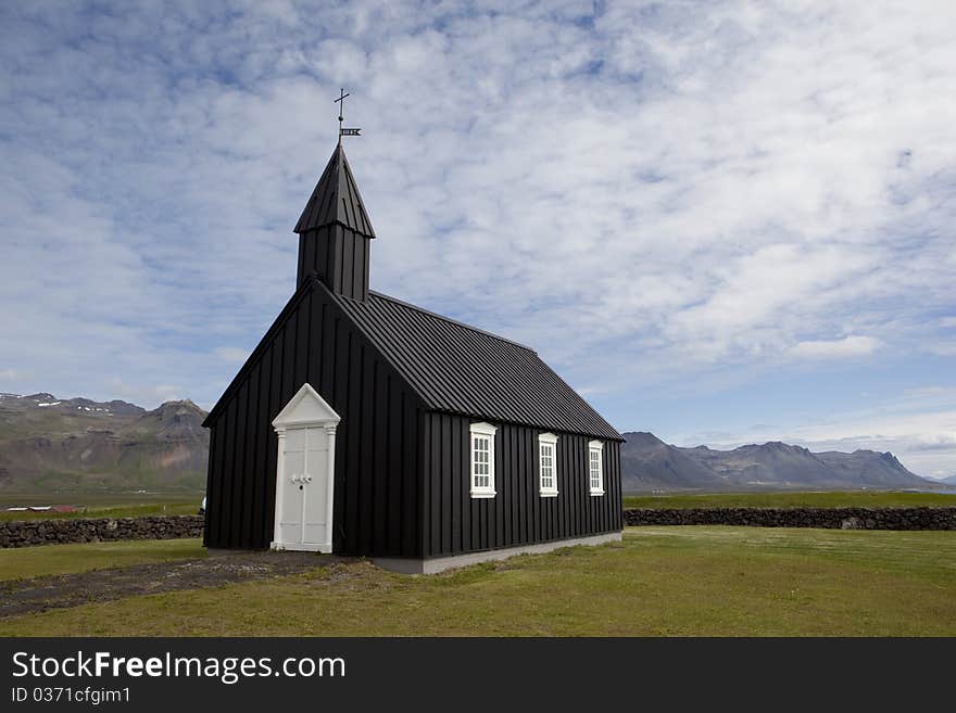 The Budir church is in the benefice of Ingjaldsholl and the Snaefell- and Dalir Deanery. The first church was built there in 1703. It was later demolished and a new one constructed. In 1816, the parish was abolished and the church was dismantled. One of the ladies of the parish fought strongly for a new church and eventually received a royal permission to build a new one, which stood ready in 1848. In 1987, it was reconstructed and consecrated the same year. Among the valuable possessions of the church are a bell from 1672 and another one without the construction year, an altarpiece from 1750, an old silver chalice, two messing candlesticks from 1767, and a door ring from 1703. The crucifix on the altar was made and donated by the goldsmith Jens Gudjonsson. The Budir church is in the benefice of Ingjaldsholl and the Snaefell- and Dalir Deanery. The first church was built there in 1703. It was later demolished and a new one constructed. In 1816, the parish was abolished and the church was dismantled. One of the ladies of the parish fought strongly for a new church and eventually received a royal permission to build a new one, which stood ready in 1848. In 1987, it was reconstructed and consecrated the same year. Among the valuable possessions of the church are a bell from 1672 and another one without the construction year, an altarpiece from 1750, an old silver chalice, two messing candlesticks from 1767, and a door ring from 1703. The crucifix on the altar was made and donated by the goldsmith Jens Gudjonsson.