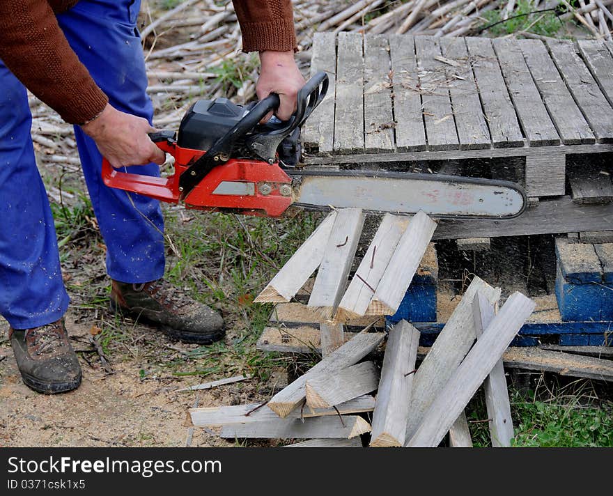 Man with mountain cutting wooden planks. Man with mountain cutting wooden planks