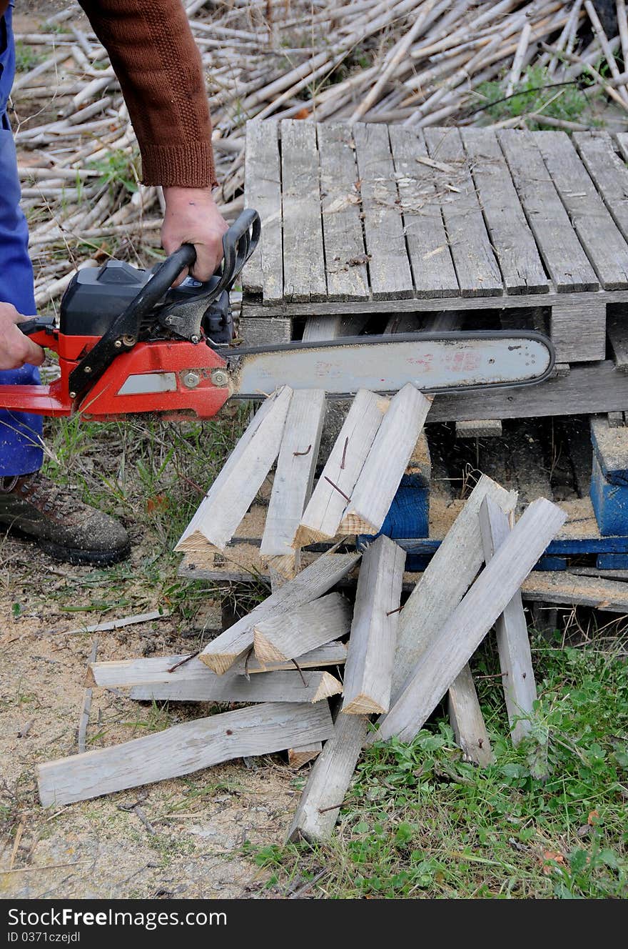 Man with mountain cutting wooden planks. Man with mountain cutting wooden planks