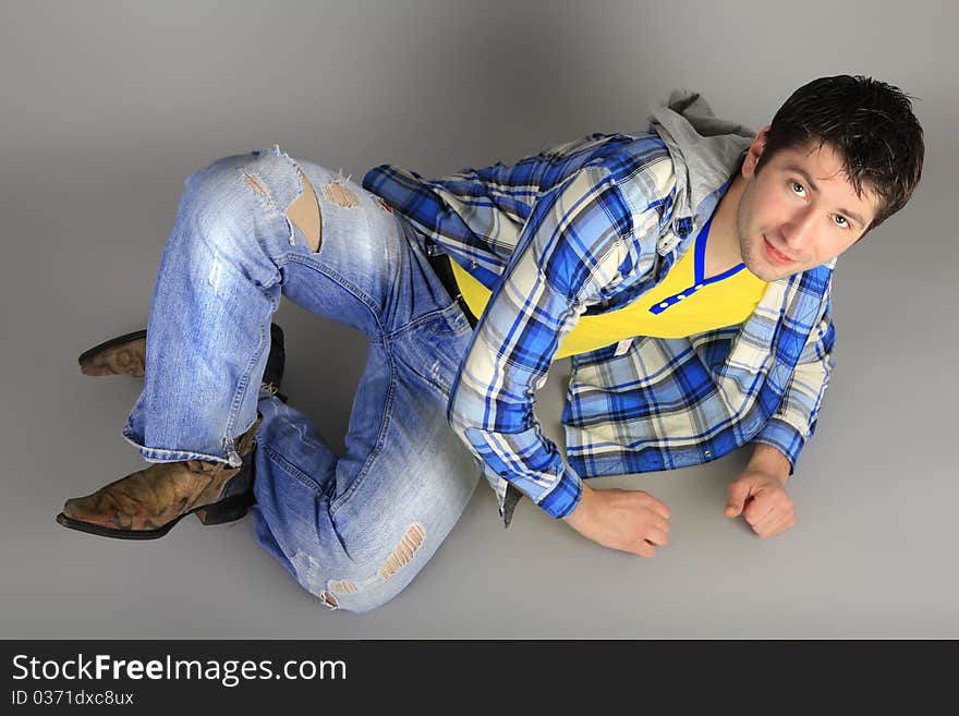 Stylish young man in jeans dancing at a party