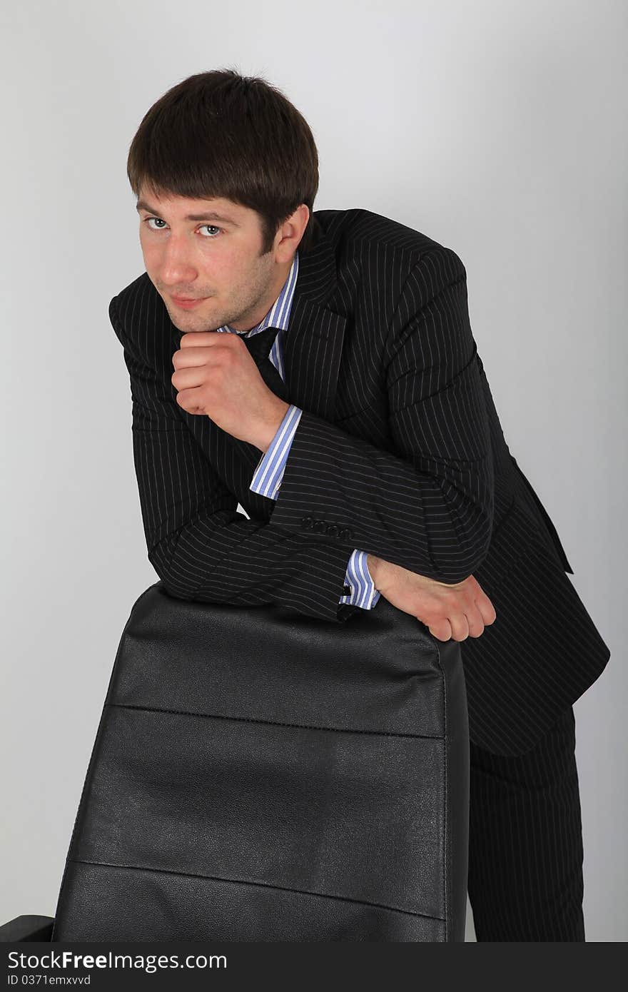 Man in business suit leaning back in his chair. Man in business suit leaning back in his chair