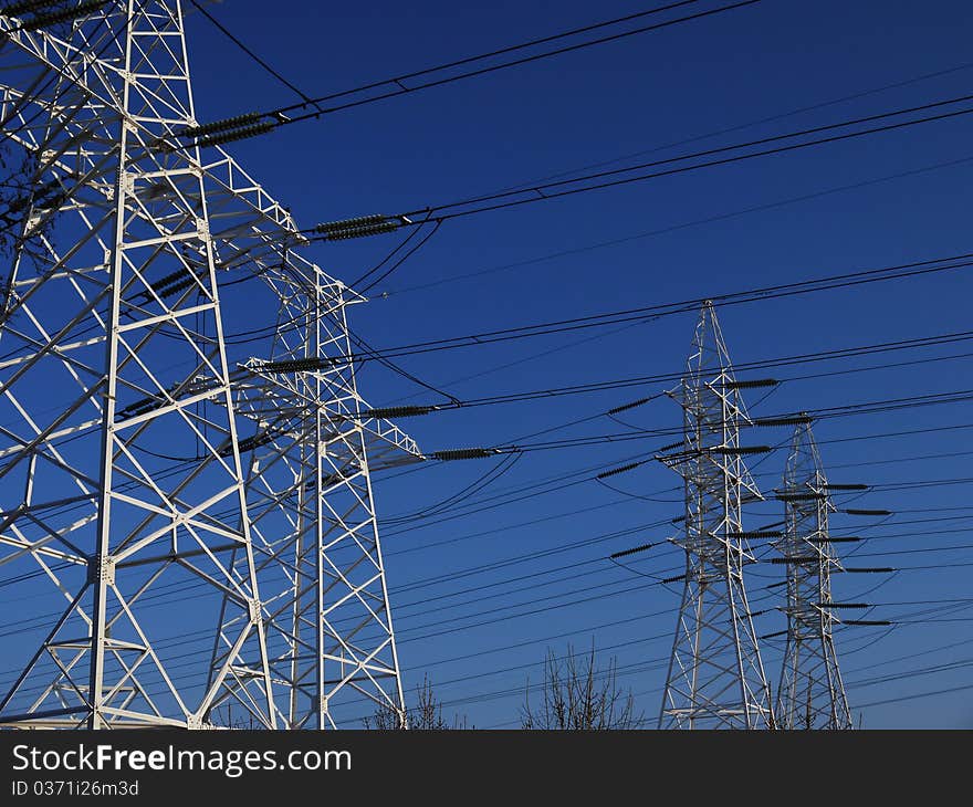 Mast high voltage lines against the background blue sky