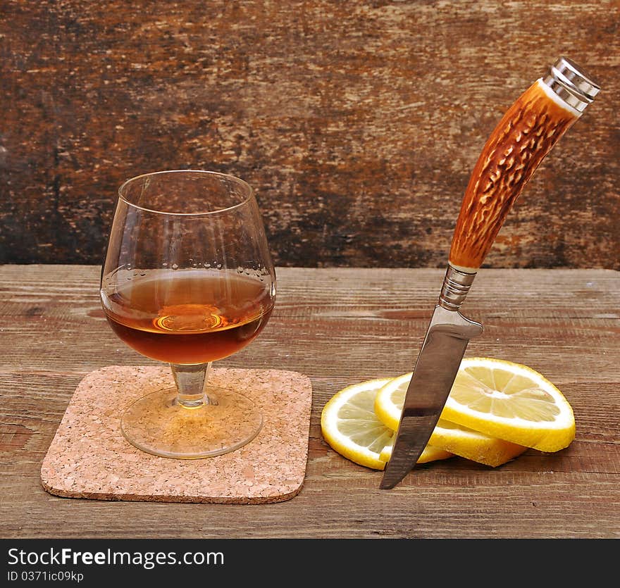 Classic cognac with lemon and knife