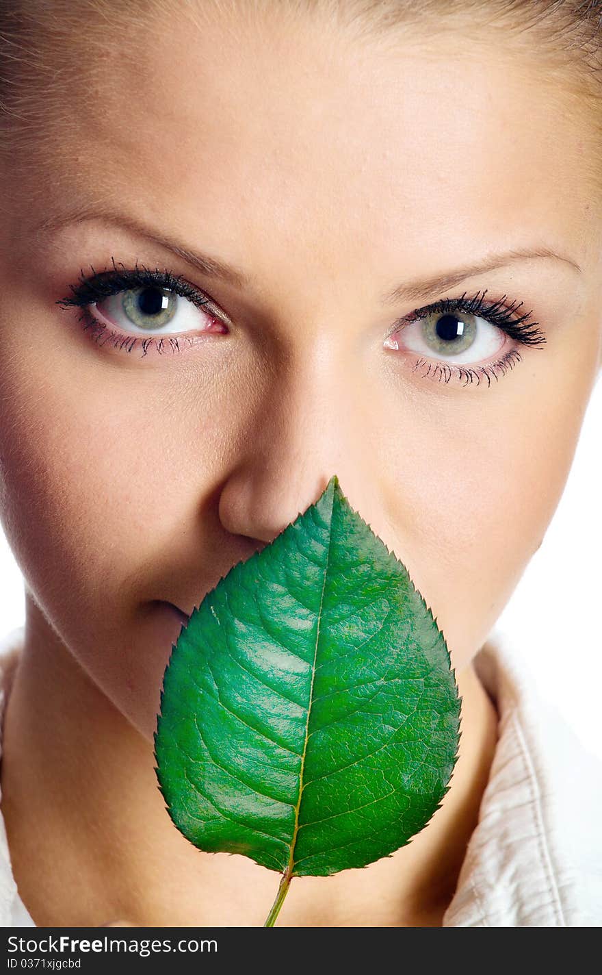 Beautiful girl with a small, green leaf. isolated