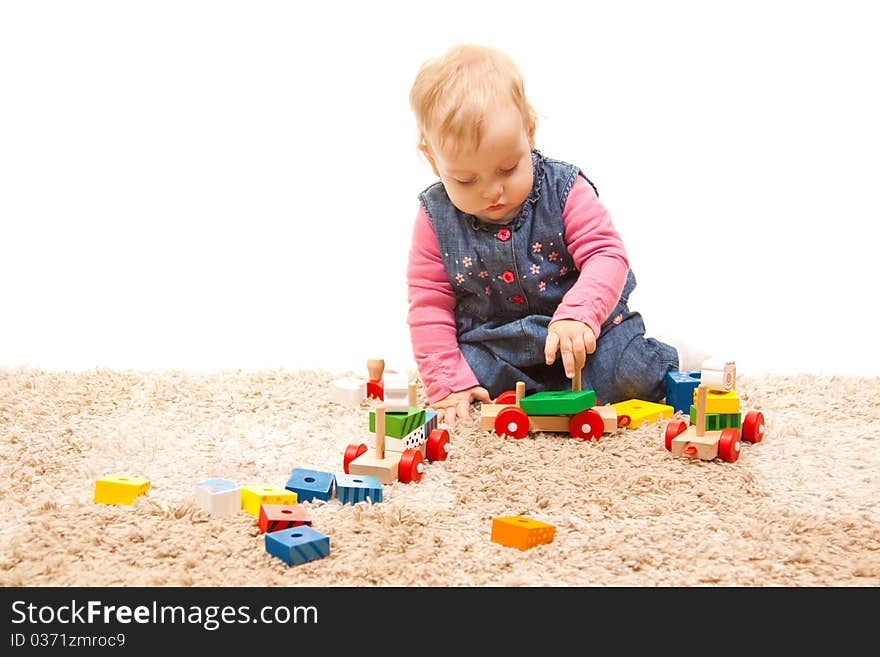 Cute little girl playing with wood toys. Cute little girl playing with wood toys