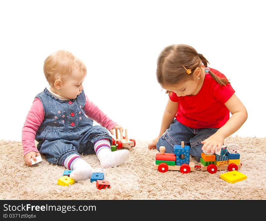 Adorable sisters playing with wood train. Adorable sisters playing with wood train