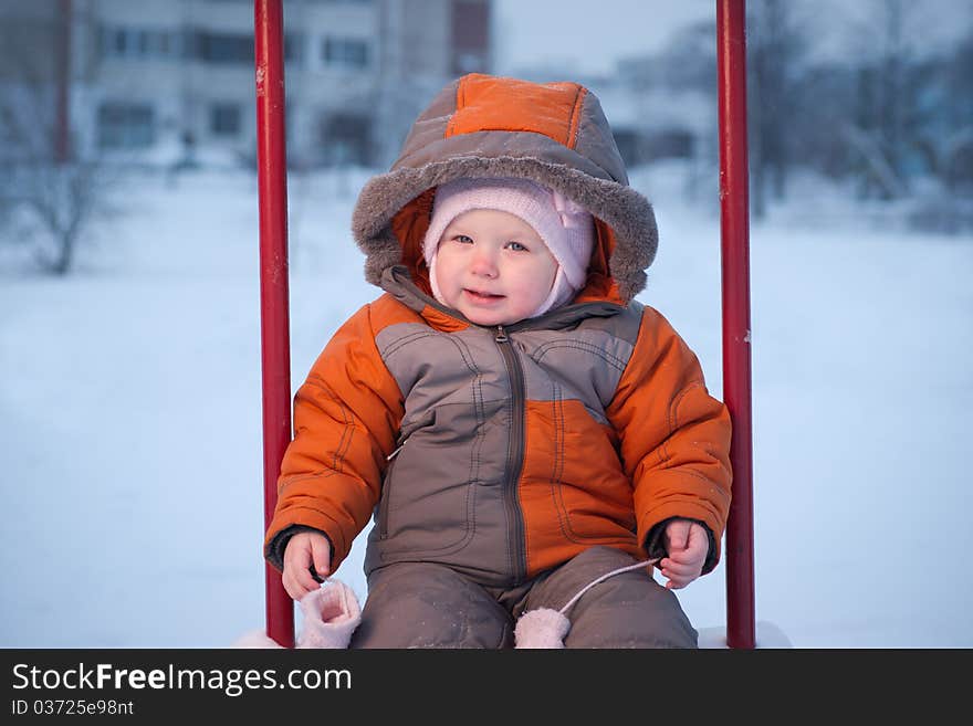 Baby sit on swing, Taking out the mittens