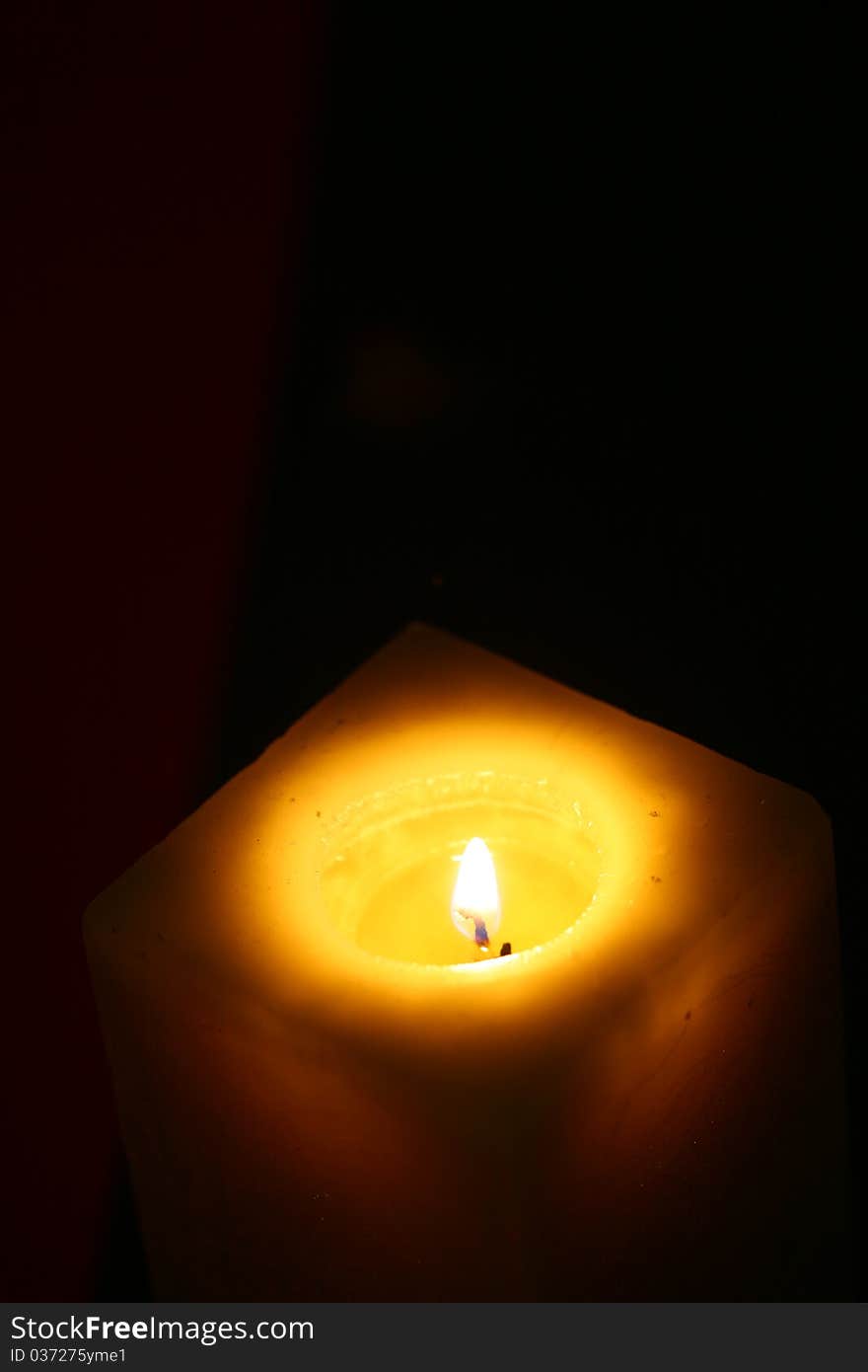 Close-up candle illuminates the darkness of the night environment. Close-up candle illuminates the darkness of the night environment