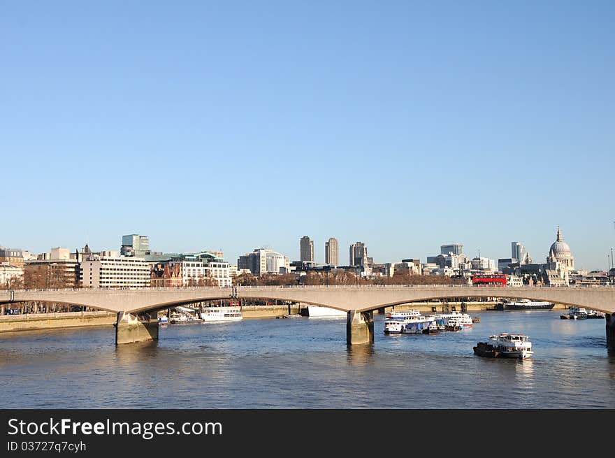 Red buses on Waterloo Bridge over River Thames in London