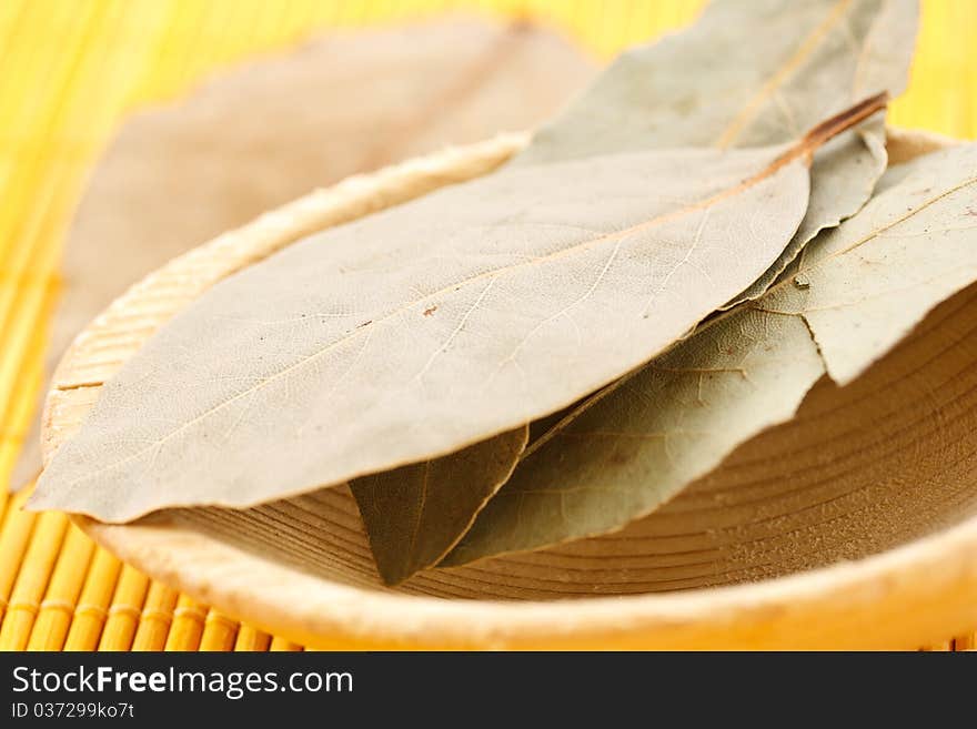 Bay leaf on a wooden spoon