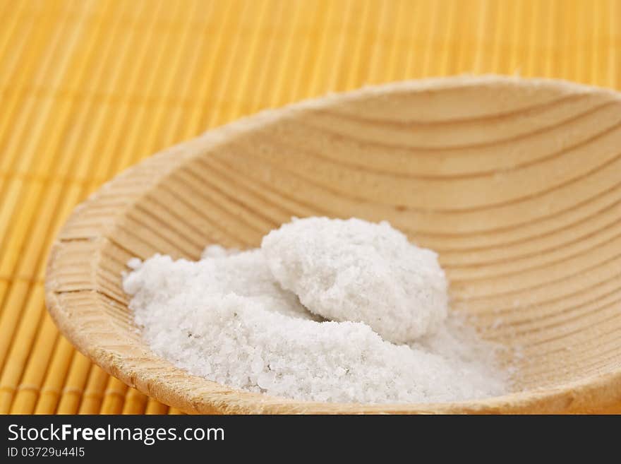 White food salt on a wooden spoon