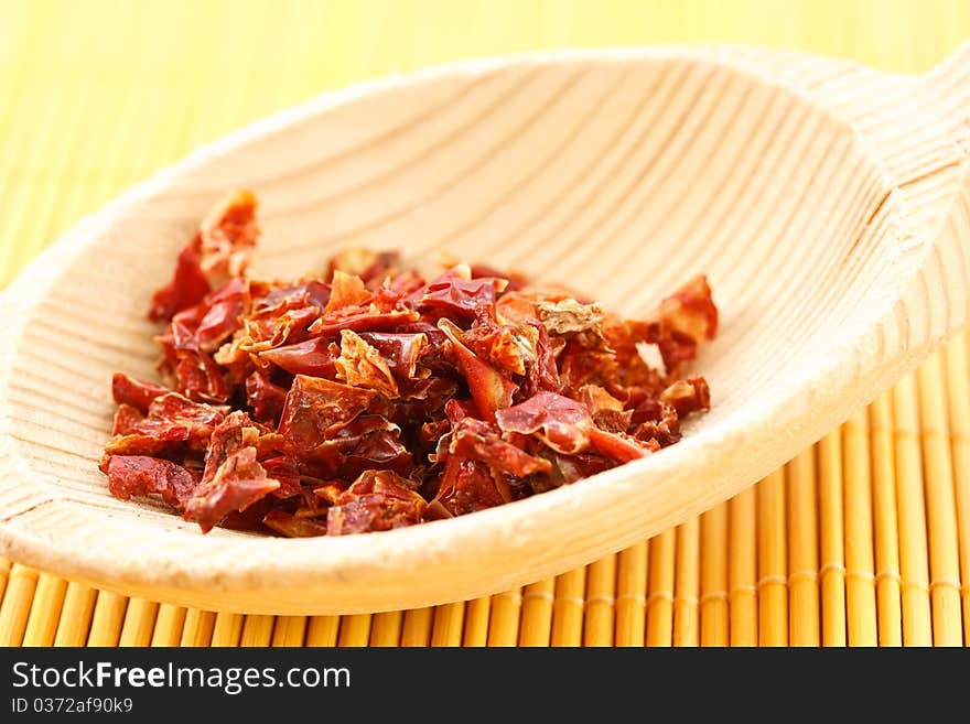 Red chili pepper on a wooden spoon