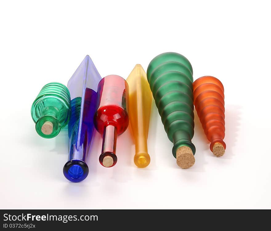 Colored glass vases on a white background