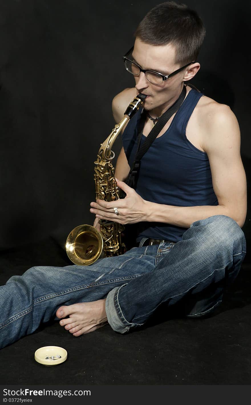 Young jazzman plays a saxophone