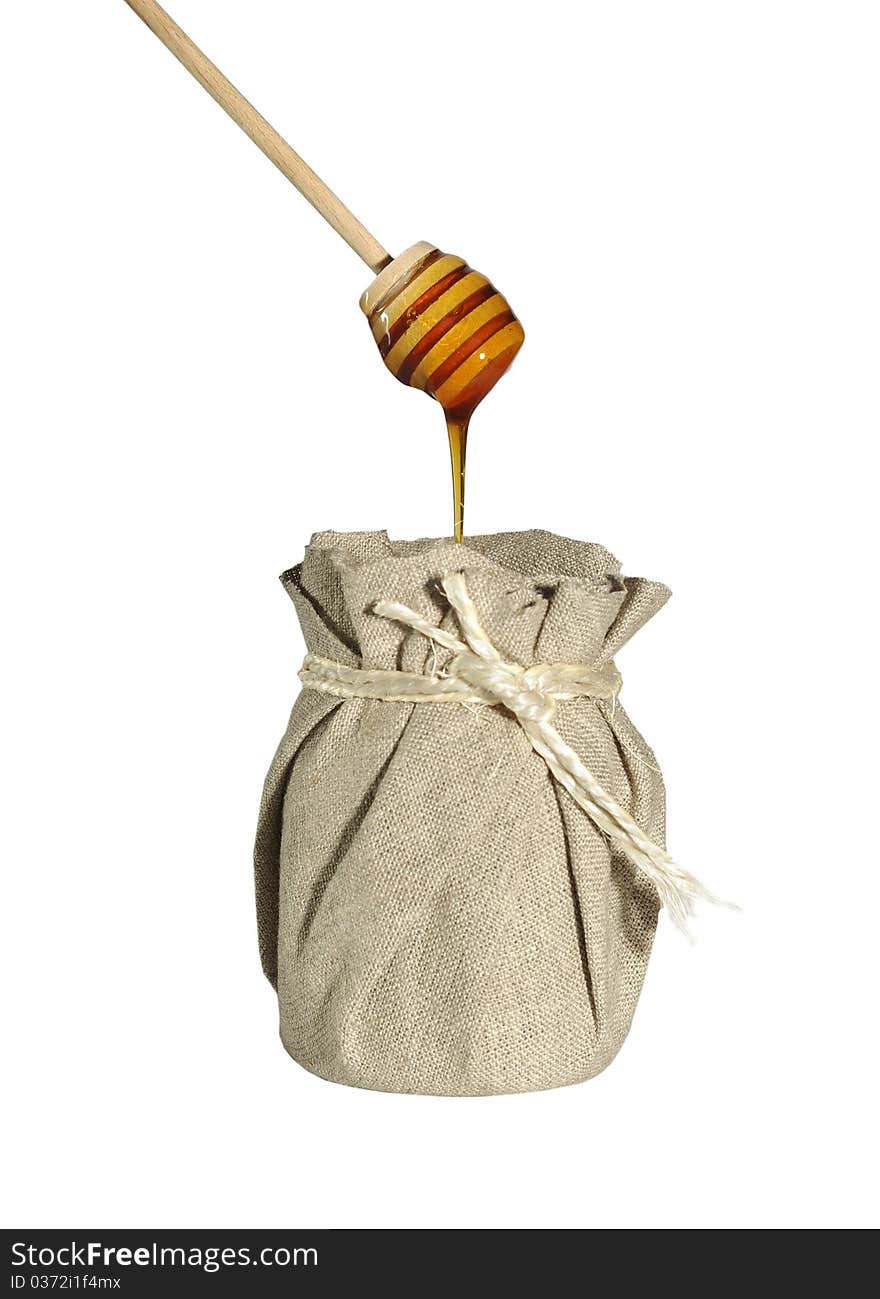 Jar of honey in canvas on white background