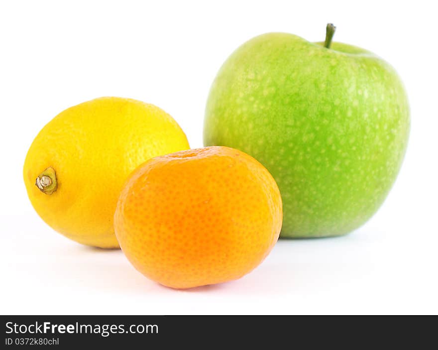 Apple, tangerine and lemon on a white background. Apple, tangerine and lemon on a white background.