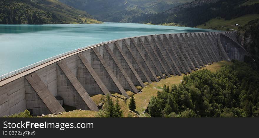 Lake and weir in alpine mountain in France on summer. Lake and weir in alpine mountain in France on summer