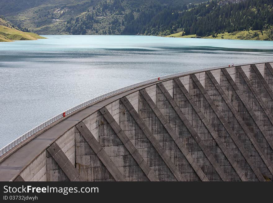 Lake and weir in alpine mountain in France on summer. Lake and weir in alpine mountain in France on summer