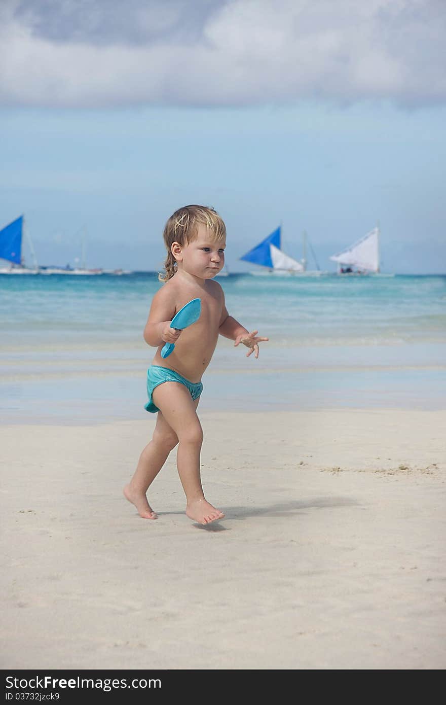 Cute child playing on beach