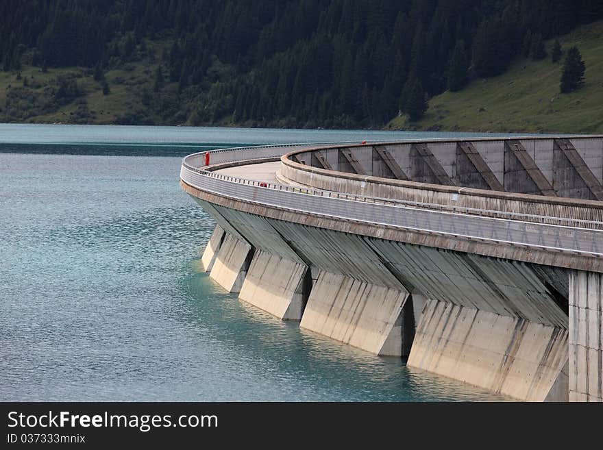 Lake and weir in alpine mountain in France on summer. Lake and weir in alpine mountain in France on summer