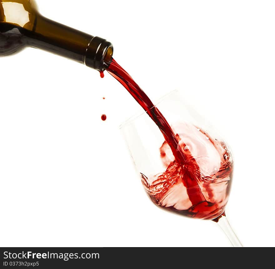 Red wine splash on a glass, white background.