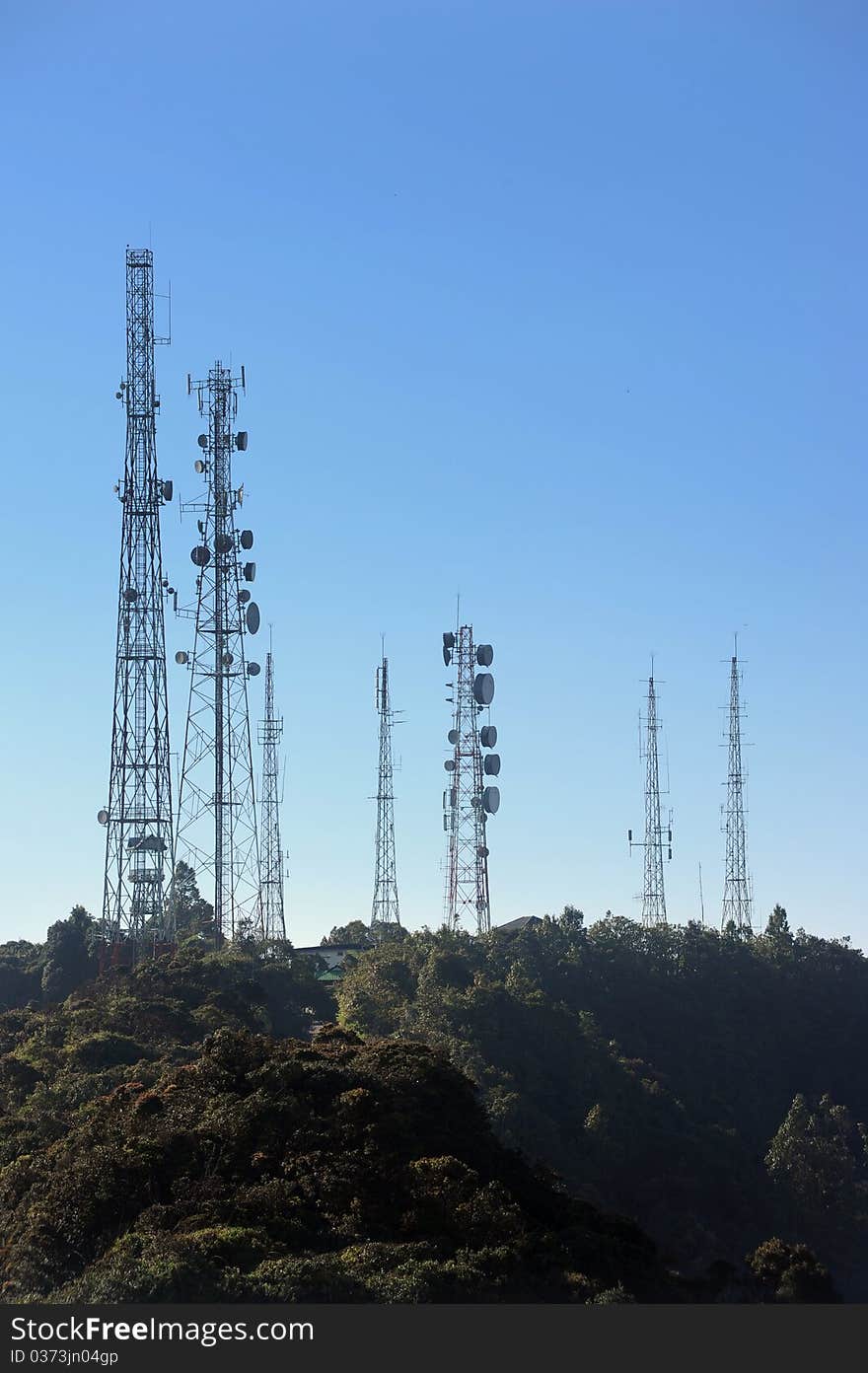 Telecommunications towers, relays and mobile radio antennas in forest.