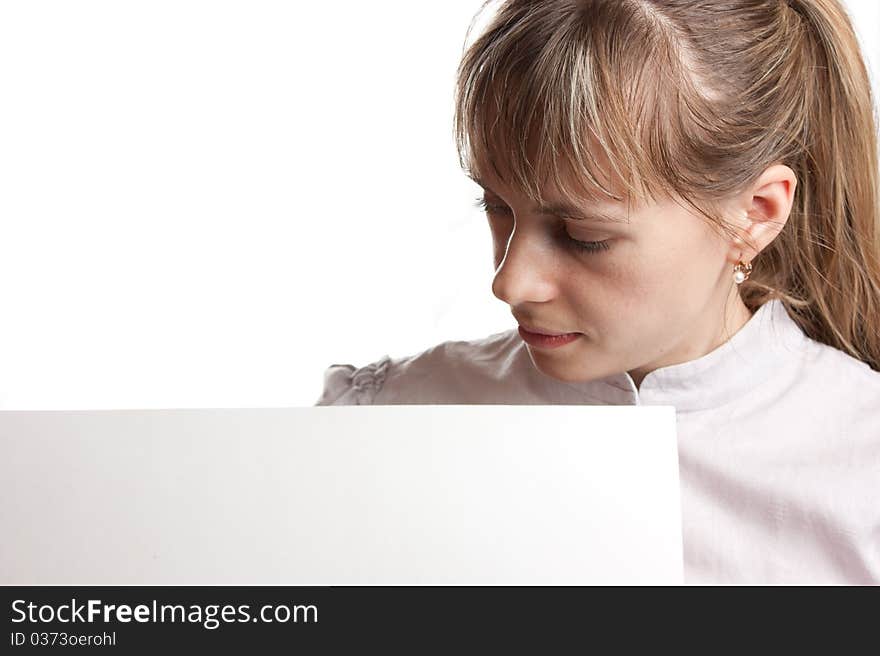 Girl looking to white paper isolated on white