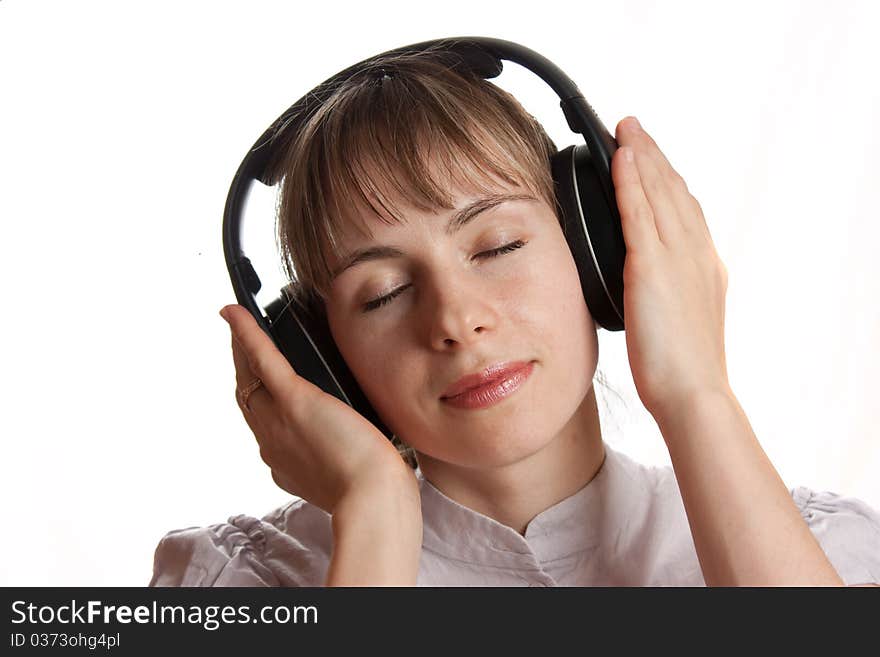 Girl listening music isolated on white