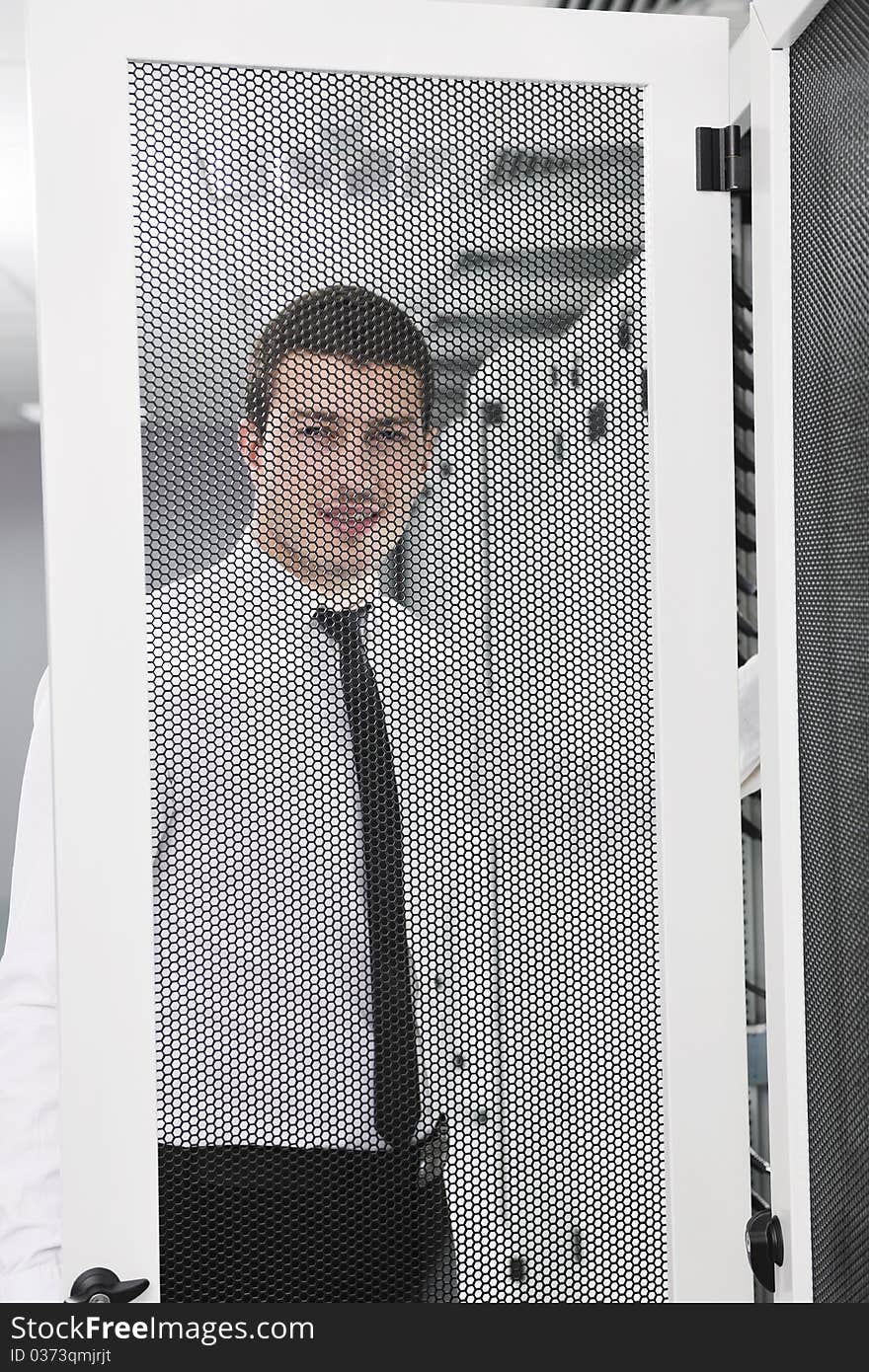 Young handsome business man it engeneer in datacenter server room. Young handsome business man it engeneer in datacenter server room