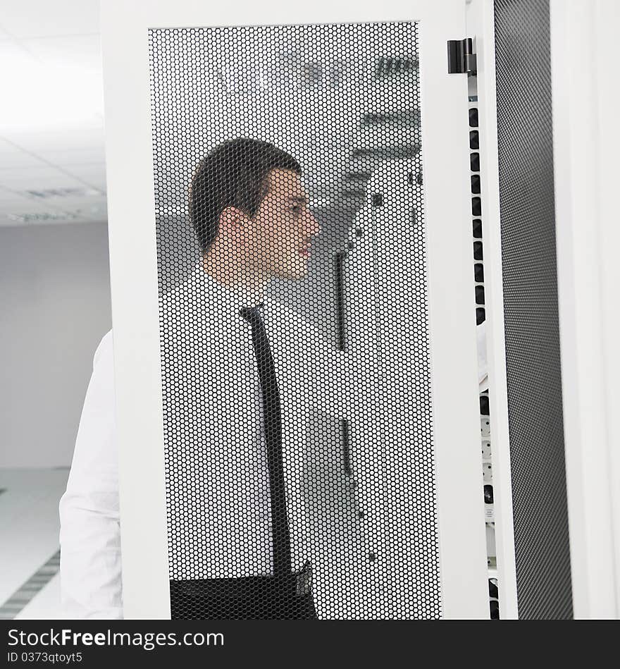 Young handsome business man it  engeneer in datacenter server room. Young handsome business man it  engeneer in datacenter server room