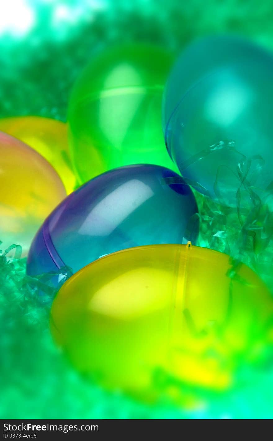 Colorful plastic Easter eggs in fake grass