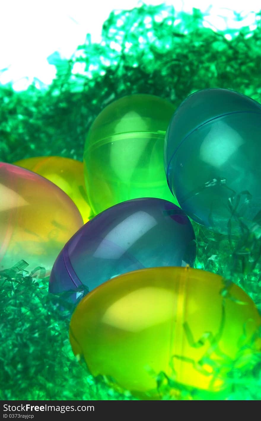 Colorful plastic Easter eggs in fake grass