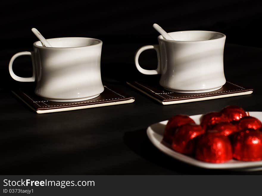 Two tea cups with sweets. Two tea cups with sweets.